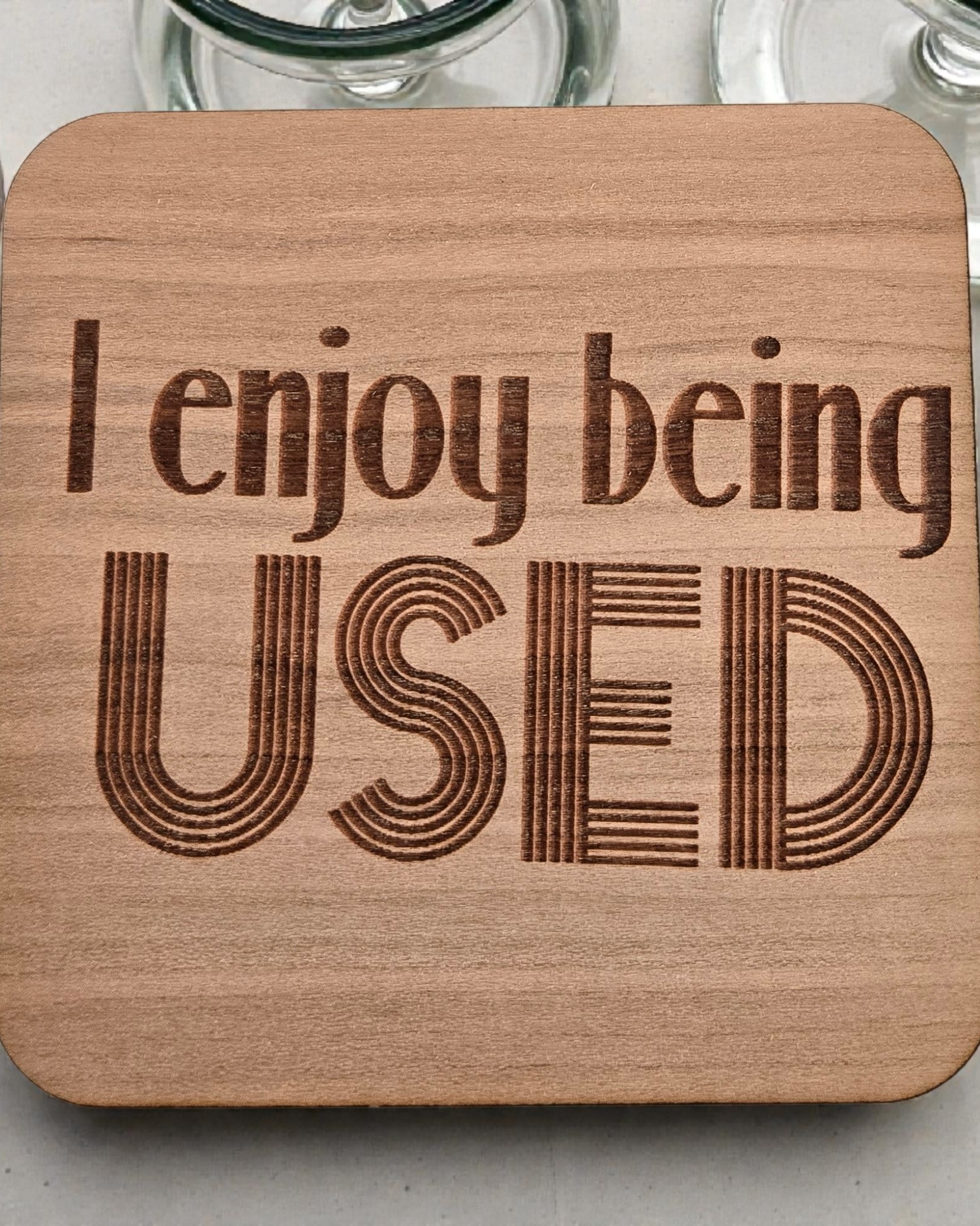 Wooden coaster with 'I enjoy being USED'