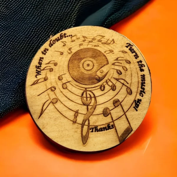 A wooden disc with music notes and a record.