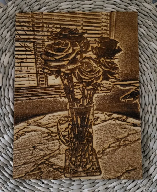 A vase of roses sitting on top of a table.