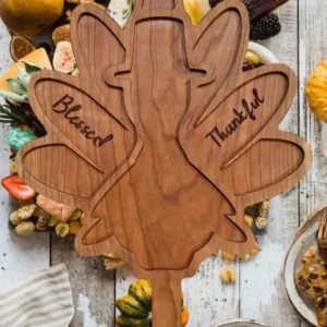 A wooden turkey with the words " blessed thankful " carved into it.