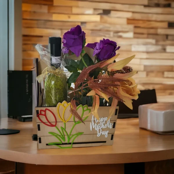 A wooden box with flowers and wine bottle on top of it.