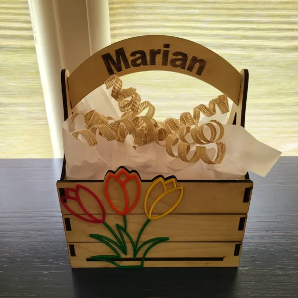 A wooden basket with some flowers on it