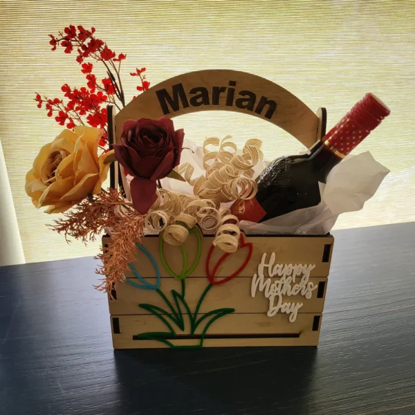 A wooden basket with flowers and wine bottle.