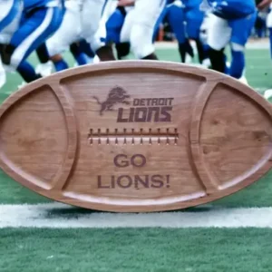 A wooden football with the detroit lions logo on it.