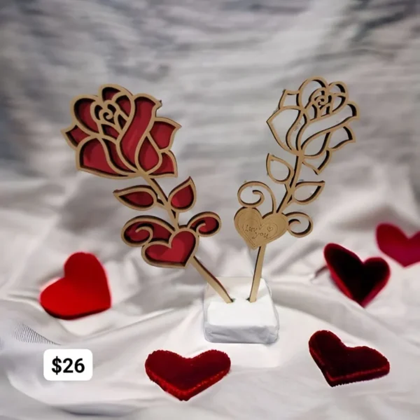 A couple of wooden roses sitting on top of a table.